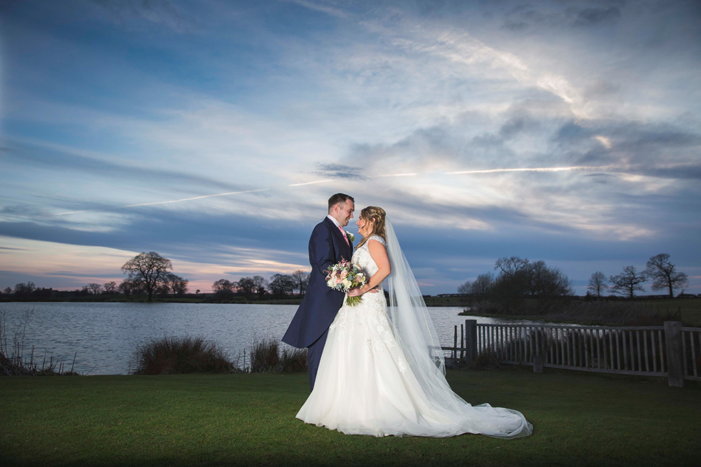 Couple stood infront of stunning lake at sunset - Carpe Diem Photography