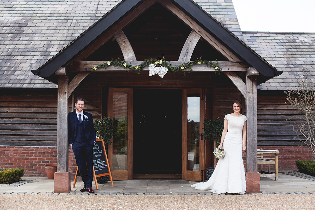 Bride and groom outside of Sandhole Oak Barn