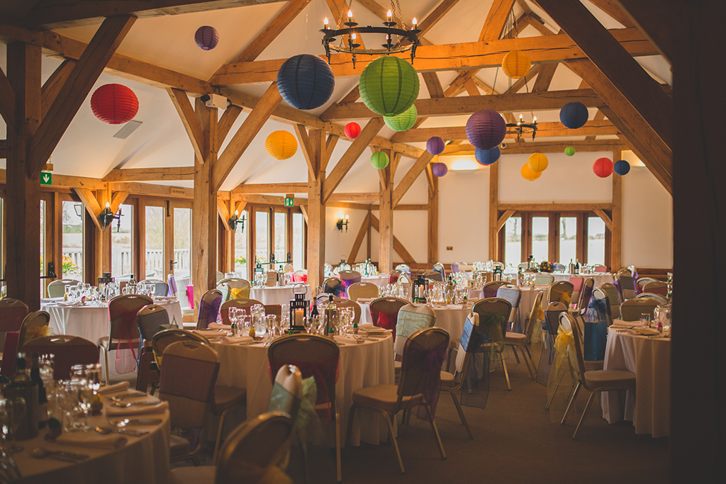 The barn was decorated with colourful lanterns and sashes at this spring wedding at Sandhole Oak Barn in Cheshire